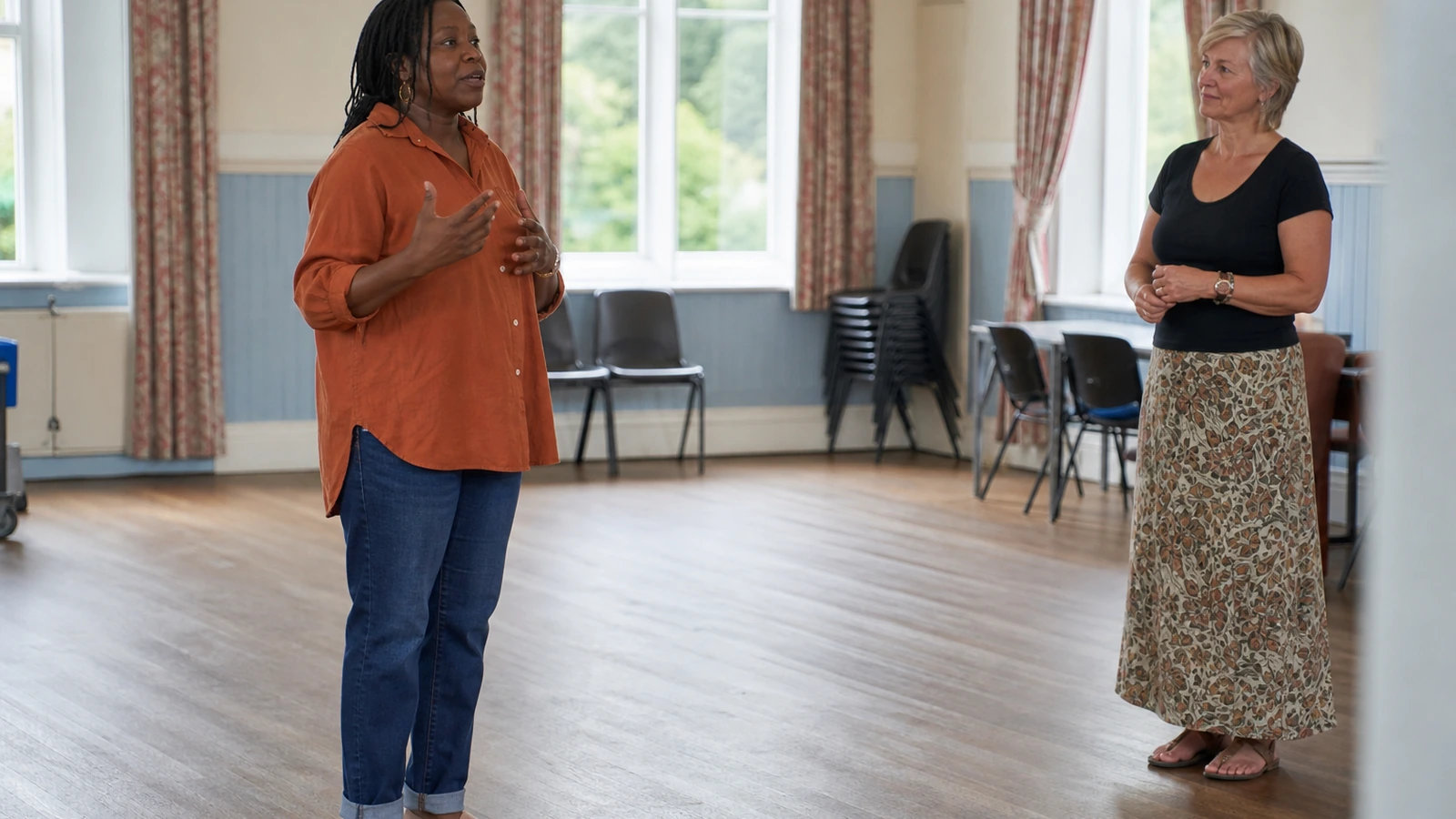 An adult learner rehearses a short presentation while a tutor listens